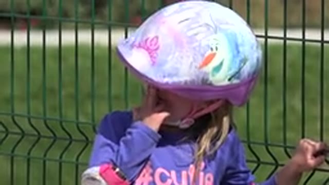 LOS CABOS MEXICO-2019: A Young Girl With A Bicycle Helmet Leans On A Fence Post