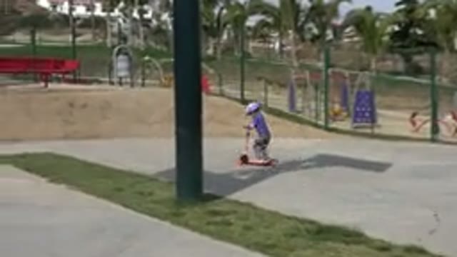 LOS CABOS MEXICO-2019: Child Rides A Scooter In The Park On A Sunny Day Next To