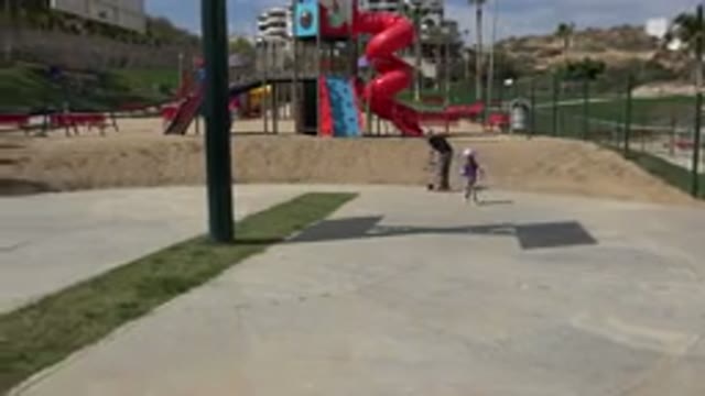 LOS CABOS MEXICO-2019: Father And Daughter Play On A Playground With Scooter