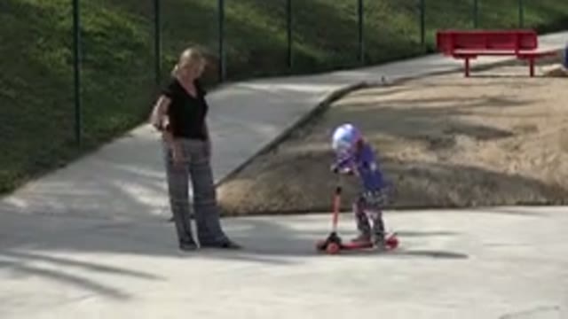 LOS CABOS MEXICO-2019: Mother Teaching Daughter How To Scooter Ride In A Sunny Day