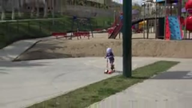LOS CABOS MEXICO-2019: Small Child Riding A Scooter In A Park With Playground
