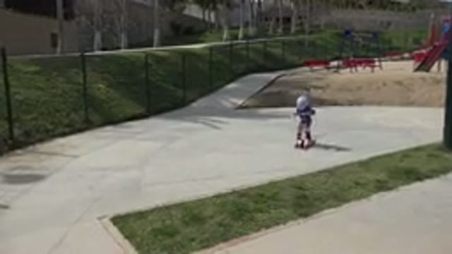 LOS CABOS MEXICO-2019: A Child Wearing a Purple Shirt, Helmet and Safety Pads Riding a Scooter