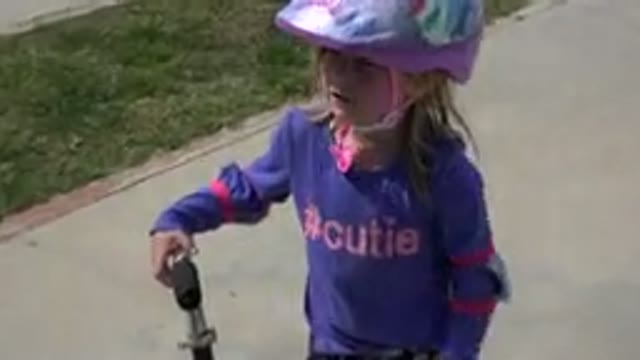 LOS CABOS MEXICO-2019: Little Girl Wearing a Helmet Learning to Ride a Scooter