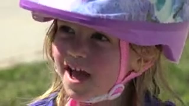 LOS CABOS MEXICO-2019: A Little Girl Wearing A Helmet Talks Before Pushing A Scooter
