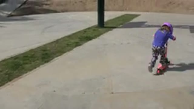 LOS CABOS MEXICO-2019: Girl Wearing Blue Shirt Rides Pink And Black Scooter On A