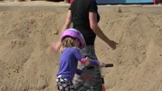 LOS CABOS MEXICO-2019: Girl Wearing Blue Shirt Prepares to Ride Orange Scooter