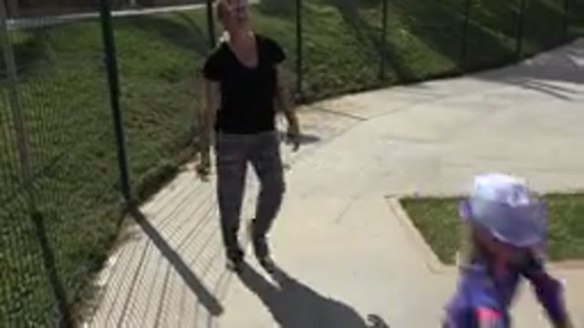 LOS CABOS MEXICO-2019: Mom In Sunglasses Laughs As She Follows A Young Properly Equipped Scooter Rider