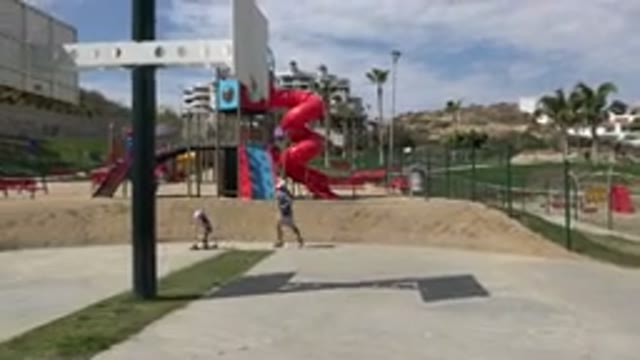 LOS CABOS MEXICO-2019: Dad Running After Small Child On Scooter In The Park