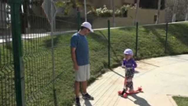 LOS CABOS MEXICO-2019: Young Girl Rides Scooter Down Sidewalk For Fun