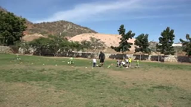 LOS CABOS MEXICO-2019: Team Soccer Kids Coach Ball Mountains Tree Grounds Funny