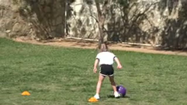 LOS CABOS MEXICO-2019: A Young White Girl Practicing Soccer Outdoors