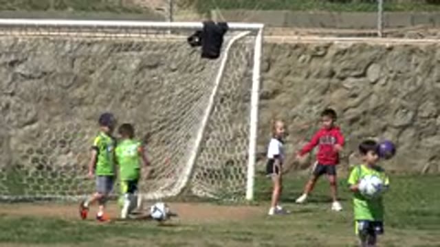 LOS CABOS MEXICO-2019: A Little Girl With Blond Hair Runs A Ball Between The
