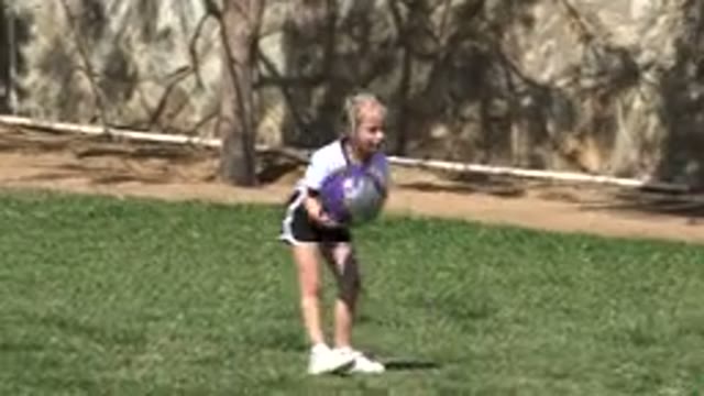 LOS CABOS MEXICO-2019: A Little Girl Picks Up A Soccer Ball And Then Holds It As