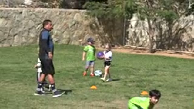 LOS CABOS MEXICO-2019: Little Girl Passes The Ball To The Other Children