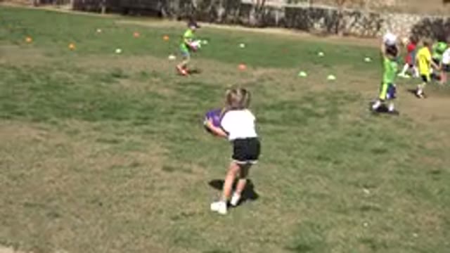LOS CABOS MEXICO-2019: Children Wearing Colorful Shirts Playing Ball on Green Field