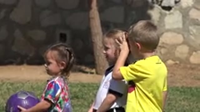 LOS CABOS MEXICO-2019: A Child Makes a Strange Hand Sign While Practicing Soccer