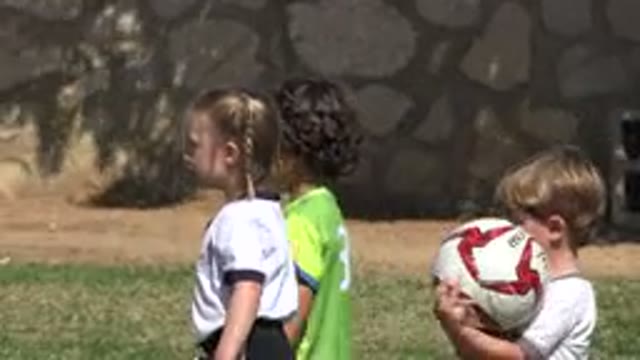 LOS CABOS MEXICO-2019: Some Little Kids Are Playing Football On A Windy And Sunny Day