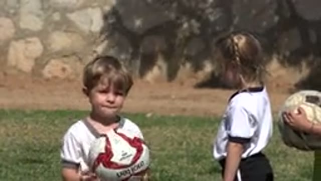 LOS CABOS MEXICO-2019: Child Gives Ball to Little Girl During Soccer Game