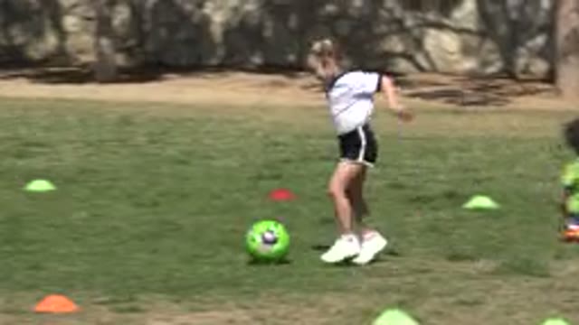LOS CABOS MEXICO-2019: A Happy Little Girl Running And Kicking A Ball Towards