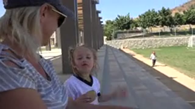 LOS CABOS MEXICO-2019: Woman Wearing Black Hat Strokes Face Of Girl Wearing