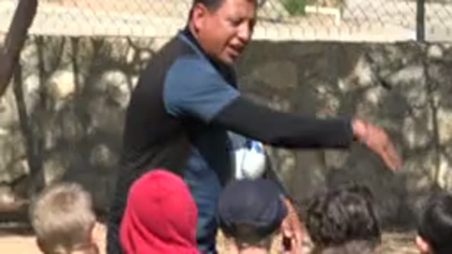LOS CABOS MEXICO-2019: Coach Explains The Rules Of The Game To Children In The Yard