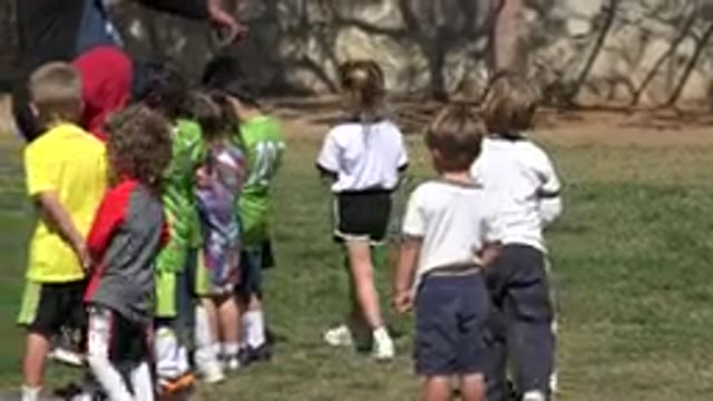 LOS CABOS MEXICO-2019: A Coach With Football Is Asking Small Kids To Stand In A