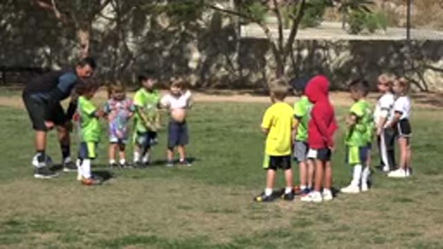 LOS CABOS MEXICO-2019: Child Wearing Red Shirt Points At Child Wearing Green