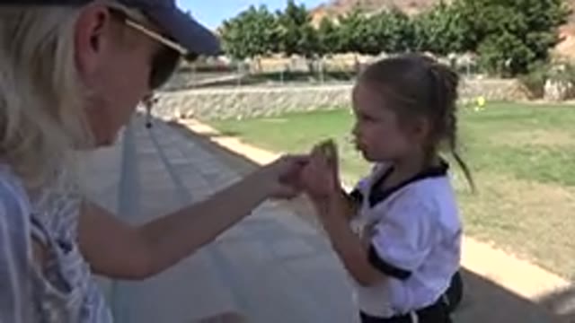 LOS CABOS MEXICO-2019: Cute Little Girl Having Refreshment From Mother While Playing