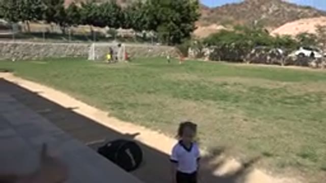 LOS CABOS MEXICO-2019: A Little Girl Playing Soccer on a Field with Other Kids
