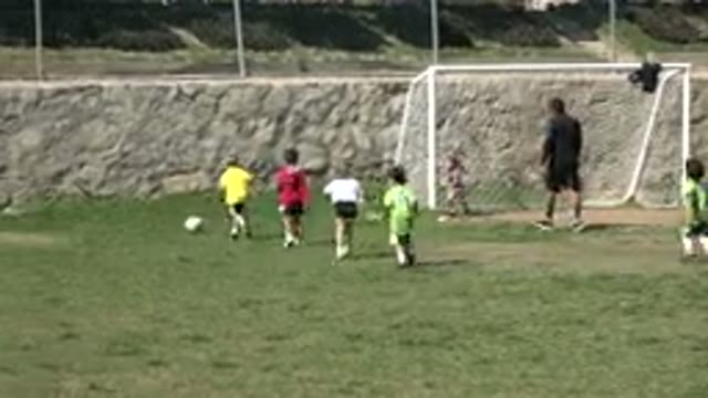 LOS CABOS MEXICO-2019: Many Kids Playing Soccer With A Ball On A Field With A Coach