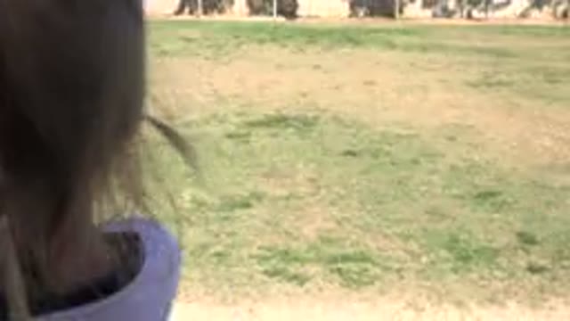 LOS CABOS MEXICO-2019: Little Girl Watching Friends Play Soccer on the Lawn