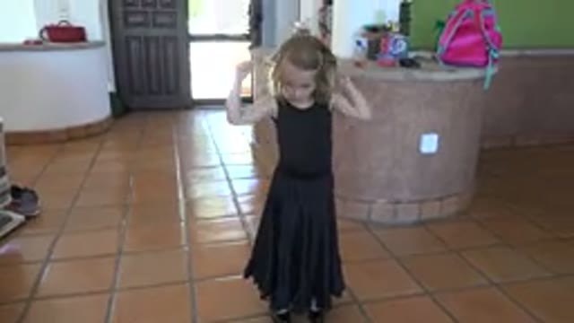 LOS CABOS MEXICO-2019: Child In A Black Dress In Kitchen Playing With Rope
