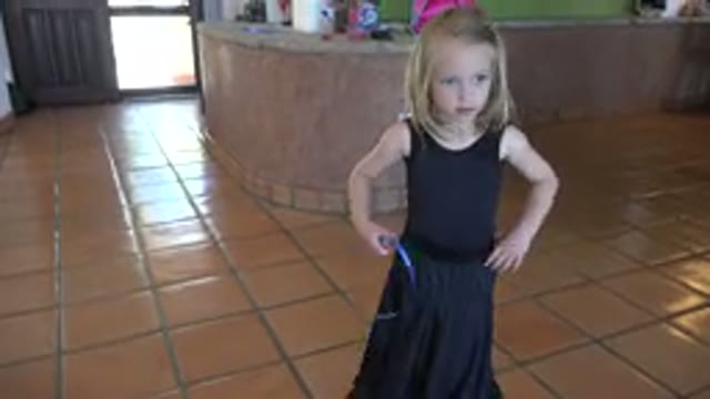 LOS CABOS MEXICO-2019: Little Blonde Girl in Black Dress with Blue String Dancing
