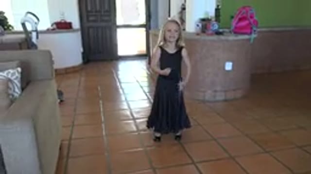LOS CABOS MEXICO-2019: A Girl In A Black Dress Holds Up A Ribbon And Spins It