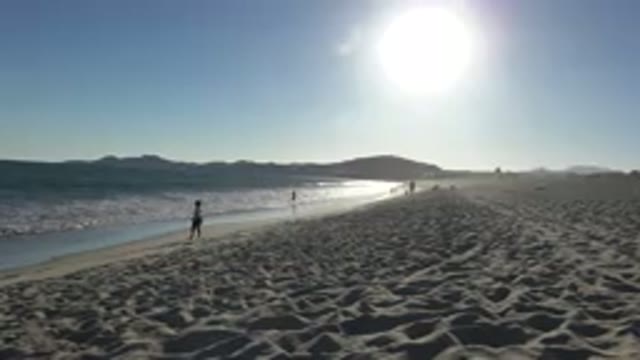 LOS CABOS MEXICO-2019: View Of Person Walking On Beach Near Surf Water On A