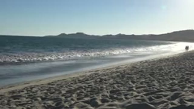 LOS CABOS MEXICO-2019: Two People Walking On Deserted Beach Sunny Day Peaceful