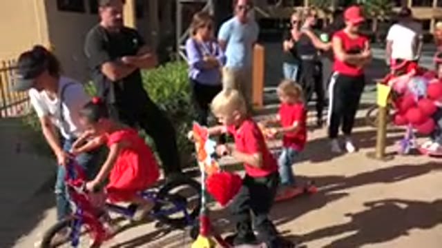 LOS CABOS MEXICO-2019: Kids Riding Scooters And Bicycles With Balloons And Heart Decorations