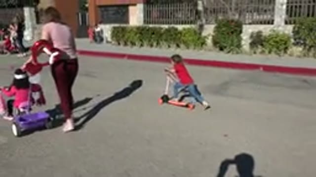 LOS CABOS MEXICO-2019: Camera Follows Little Girl As She Pushes Her Scooter Down