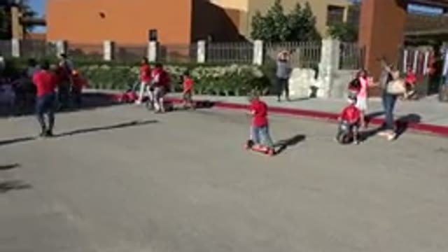 LOS CABOS MEXICO-2019: Girl Wearing Red Shirt Rides Pale Pink Scooter On A