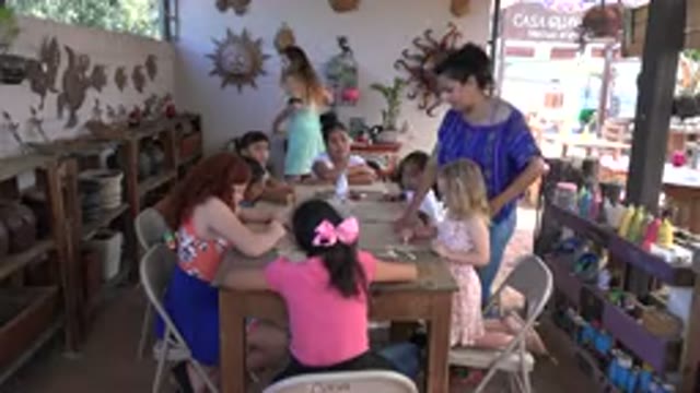 LOS CABOS MEXICO-2019: Girls Sit At A Table And Work On Art While Two Women