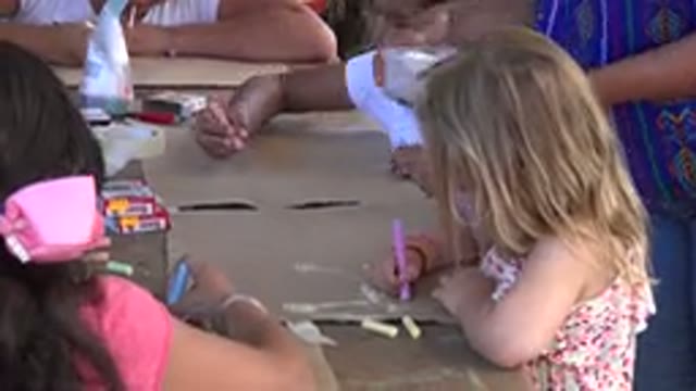 LOS CABOS MEXICO-2019: Young Girl With a Group of Children Playing With Crayons
