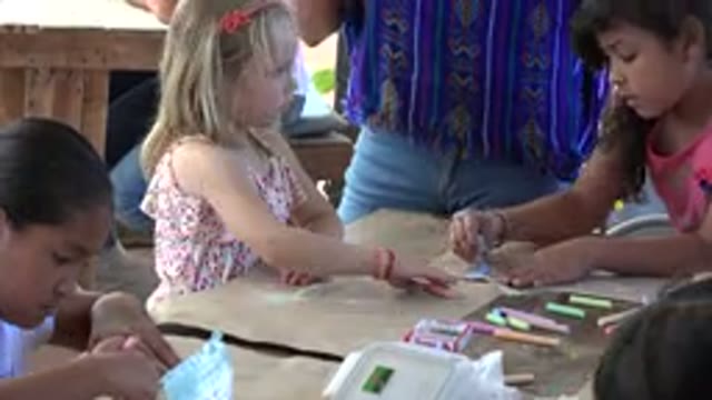 LOS CABOS MEXICO-2019: Teacher Teaching Kids To Draw In A School In Los Cabos