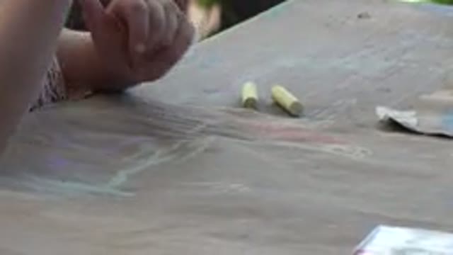 LOS CABOS MEXICO-2019: Little Girl Draws With Chalk On Unbleached Brown Paper