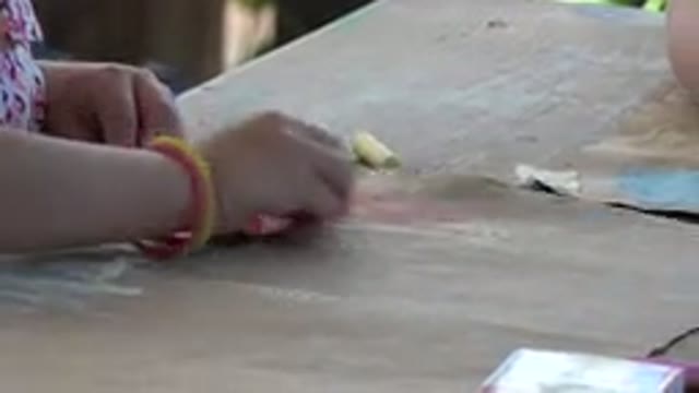 LOS CABOS MEXICO-2019: Child With Colorful Bracelet Playing Drawing Or Studying