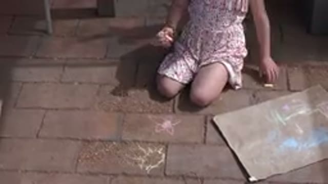 LOS CABOS MEXICO-2019: Blonde-Haired Girl Draws On The Ground With Colored Chalks