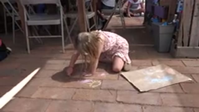 LOS CABOS MEXICO-2019: A Young White Girl Drawing On Bricks With Chalk