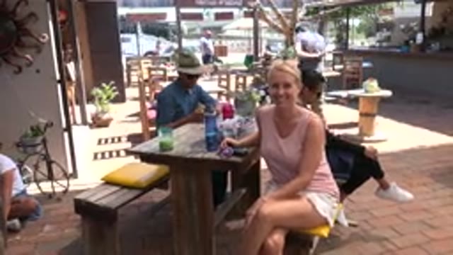 LOS CABOS MEXICO-2019: Woman Smiling And Waving At A Camera While At A Cafe