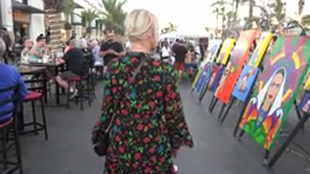LOS CABOS MEXICO-2019: Girl With Flowery Dress And A Child At An Art Exhibition