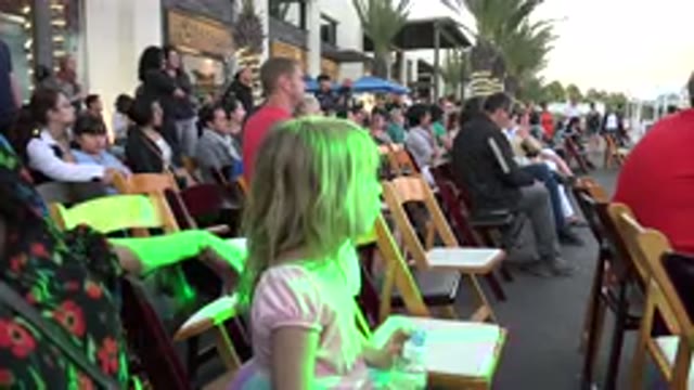 LOS CABOS MEXICO-2019: Little Girl Sitting on Chair at Festival with Mother