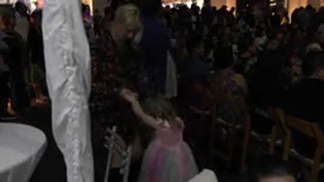 LOS CABOS MEXICO-2019: Woman Dances With Little Girl In Pastel Colored Dress At